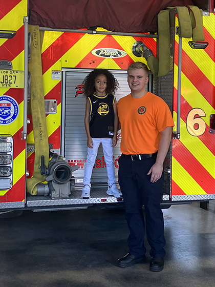 grace christian academy student with firefighter